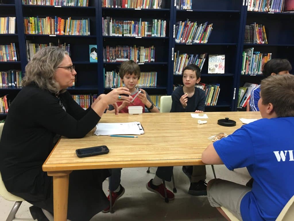 Maria Archer, K8 principal uses a talking piece with 6th grade boys' Neighbor Group.