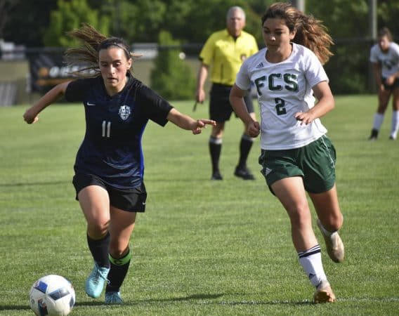 Eastern Mennonite’s Ava Galgano (11) gets ahead of Fredericksburg Christian’s Catie Jones on Wednesday during the Flames’ 2-0 loss in the VISAA Division II girls soccer quarterfinals at EMHS.

Jim Sacco / DN-R