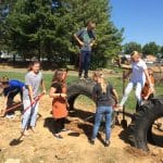 Eighth grade science class works on EMES playground tire project. 