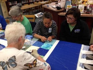 Volunteers -- including aunts, grandmothers, mothers and friends of current students -- helped with the quilting on History Day 2017