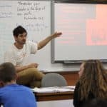 Caleb Schrock-Hurst in AP World History class discussing "interpretations of the Vietnam War: Why such different points of view?" EMS photo.