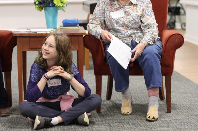 Fifth grader Grace Fairfield listens attentively to a resident and new friend at Virginia Mennonite Retirement Community.