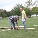 EMS dad Dwight Huyard (right) consults with Sam Petersheim, as they begin to build the outdoor stage. 