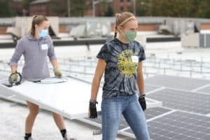 Sidney Rhodes'22 and Karla Hostetter '21, EMS Sustainablity club members at the solar barn raising