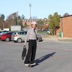 Curt Stutzman arrives for a day at work on his OneWheel, tie flying...