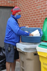 Kendal Bauman, faculty club sponsor, brings elementary school compost to the main collection bins each week.