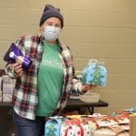 Jennifer Young retrieving her faculty/staff Christmas tea box