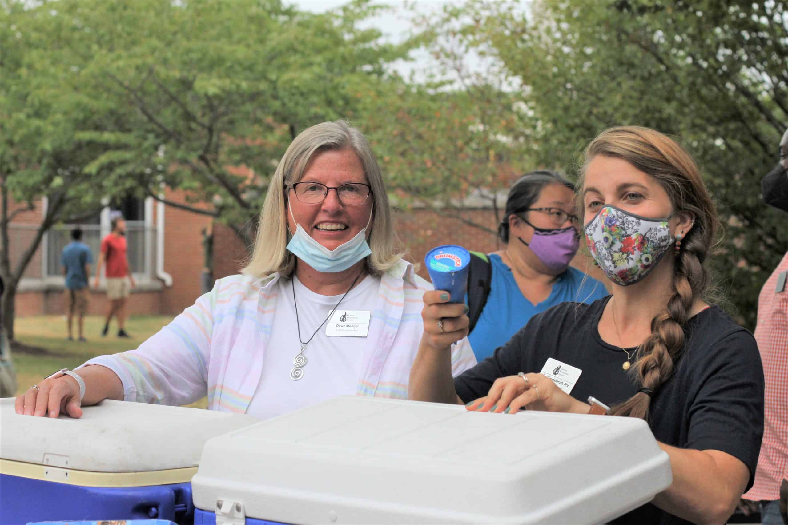 Dawn Monger, left, and Caitlin Tice, distribute ice cream during Back to School night in fall 2021
