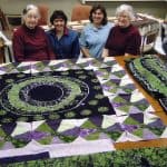 Gladys Driver (left), Yvonne Martin, Jan Kauffman, and Brownie Drive (right) with African Kaleidoscop Quilt, Weavers Mennonite Church, 2005. Photo courtesy of Dorothy Kreider. 