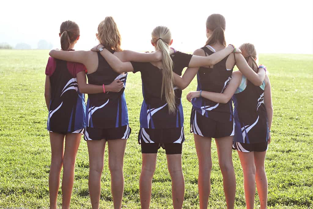 track teammates with arms around each other