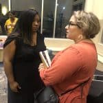 Osheta Moore visits with a community member 