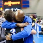 Eli Crawford, head boys varsity basketball coach hugs Adam Hatter '22 after the big win