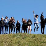 Students jump on hill in Mississippi on e-term trip