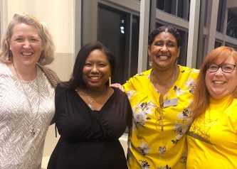 Four women pose after Osheta Moore's talk