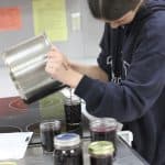 Making grape jelly with local grapes in the fall of '22 local food class