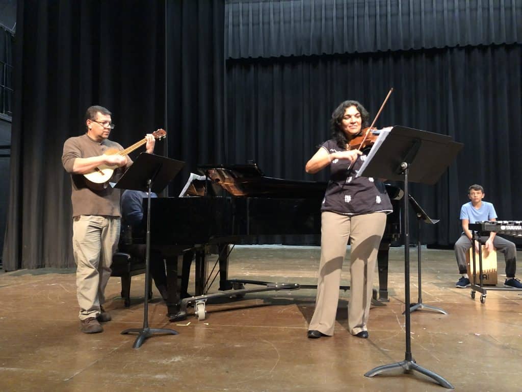 Strings teacher Maria Lorcas organized student and professional musicians for a Latino music chapel