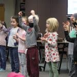 Students lead a song with American Sign Language during Gathering