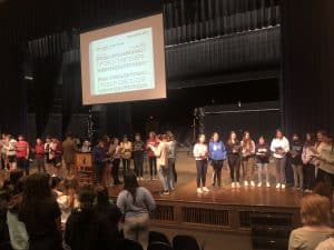 Students help lead a chapel with four part a capella singing